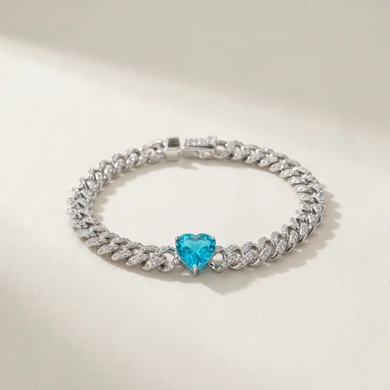 Aqua heart pavé curb bracelet on an off-white surface