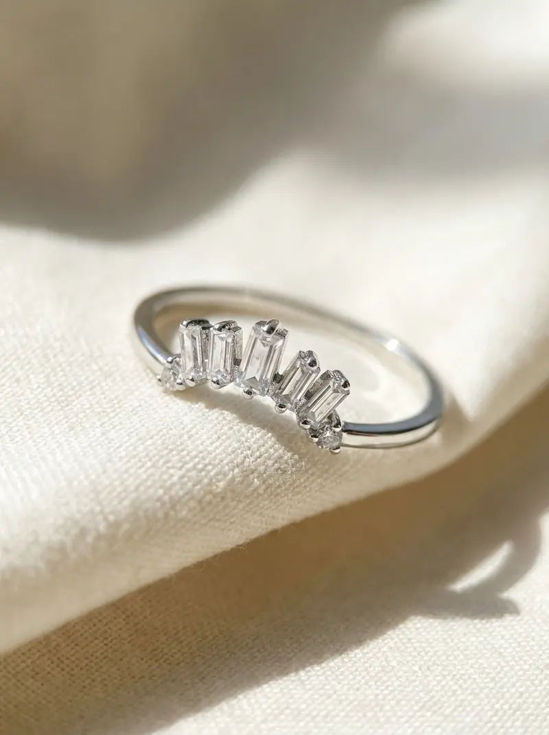 Close-up of the silver baguette crown ring on folded linen