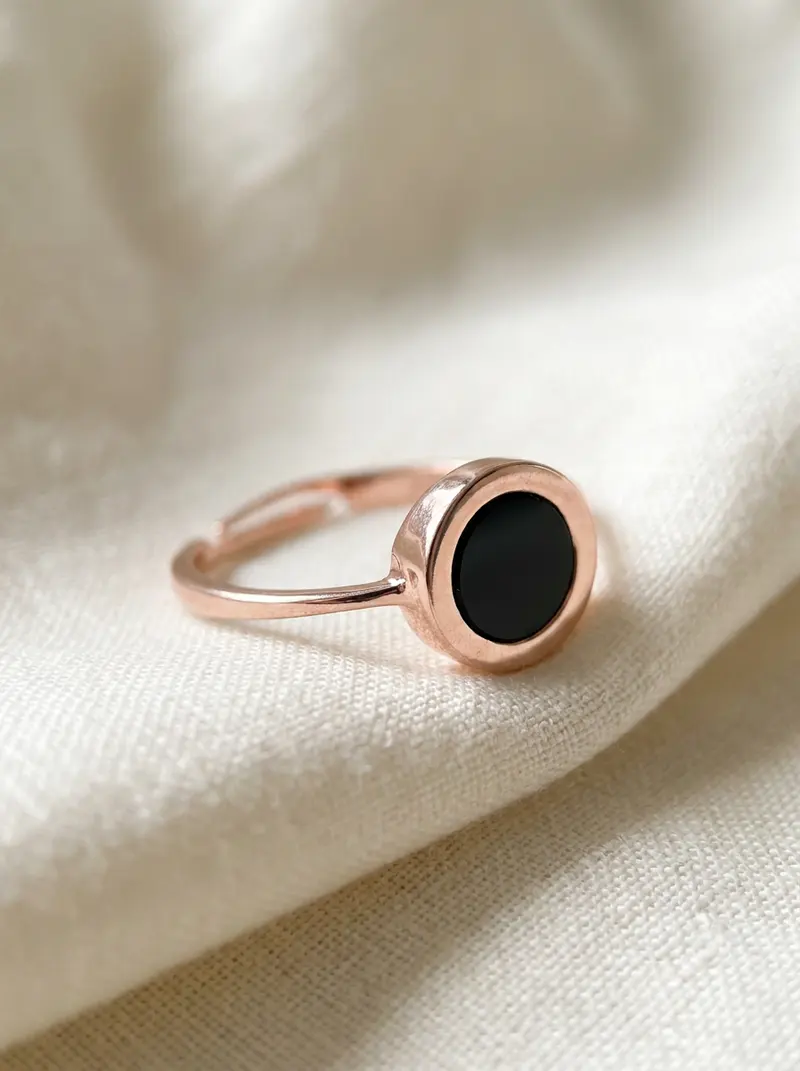 Close-up of the black onyx round ring on folded linen