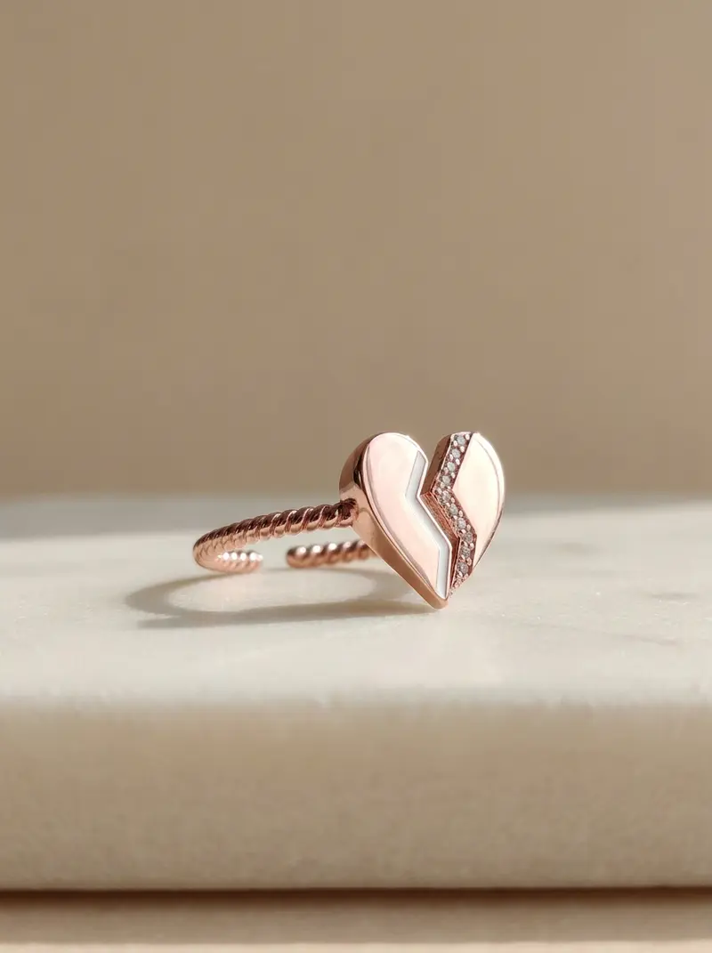 Broken heart ring resting on its side on an ivory slab