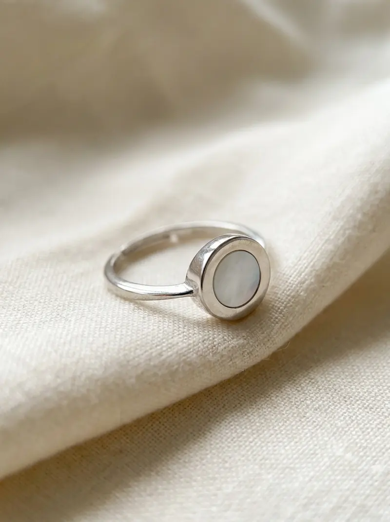 Mother-of-pearl ring on folded linen