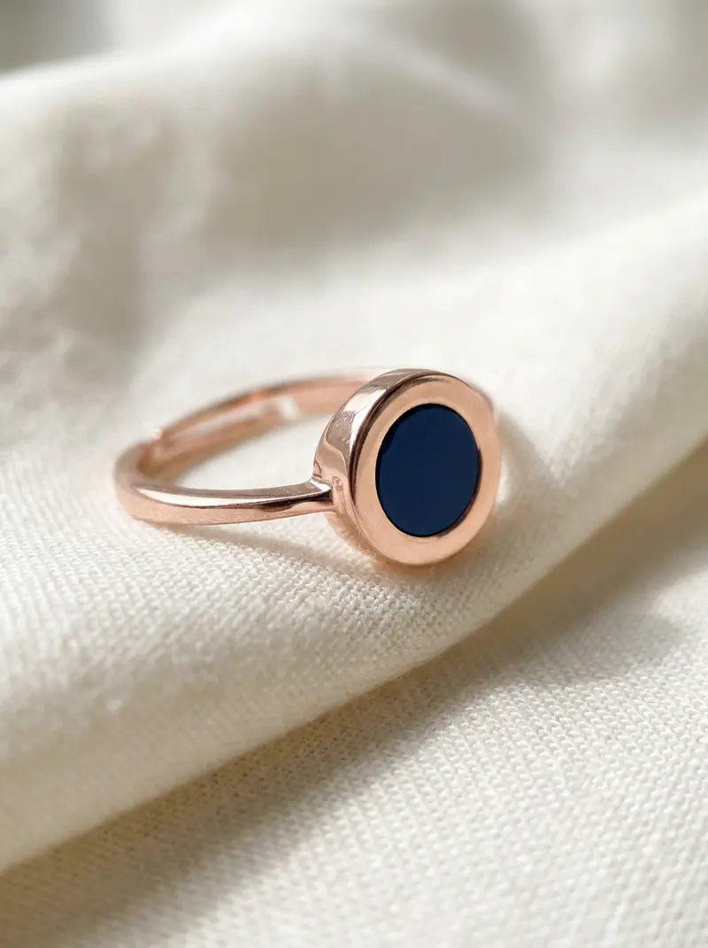 Close-up of the navy round ring on folded linen