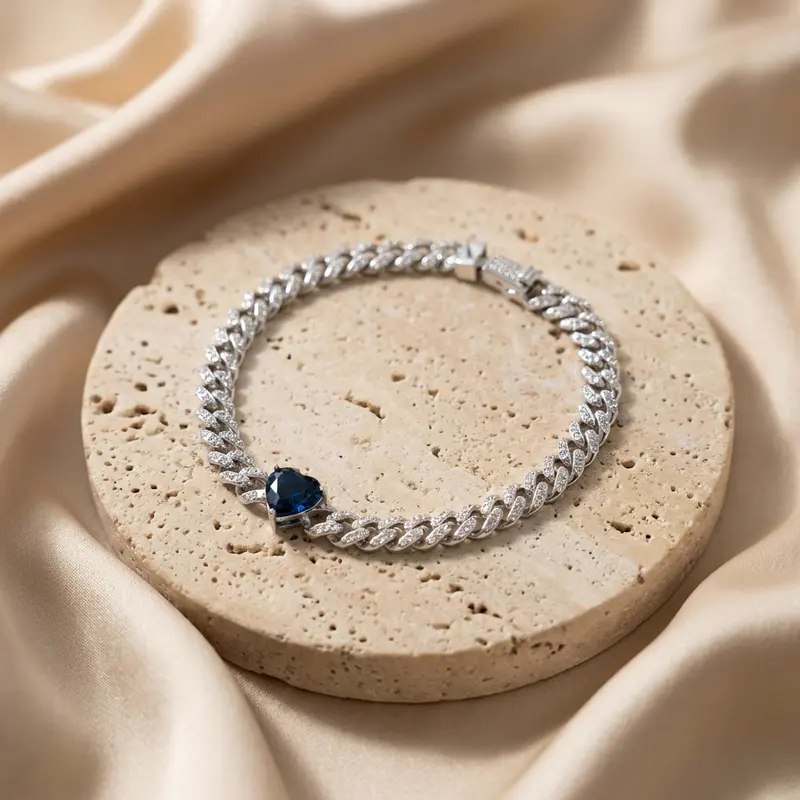 Sapphire heart pavé curb bracelet on a travertine disc with silk